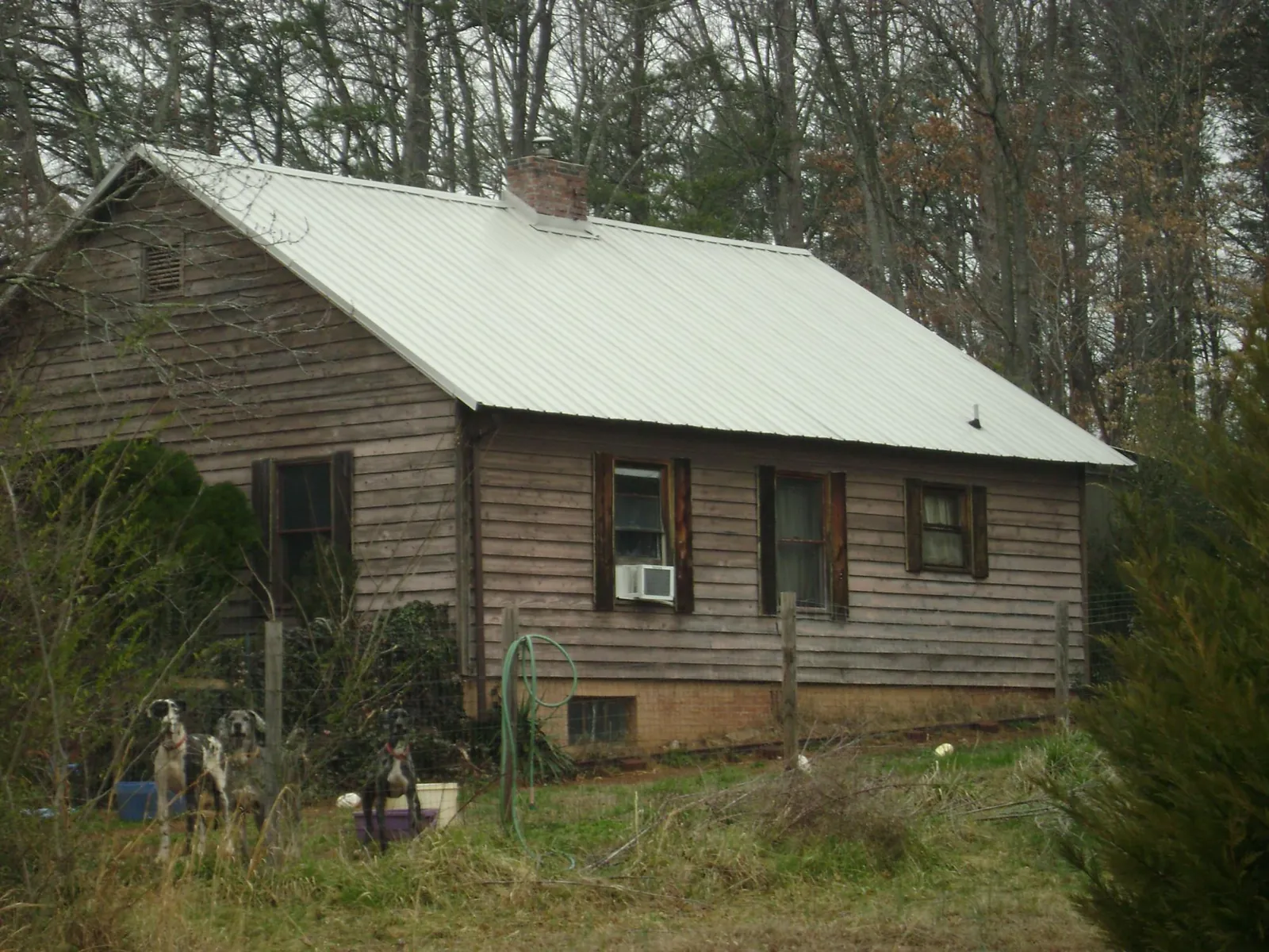 White metal roof on an old wood sided farmhouse, from a Metal Roof Installation job in Westover
